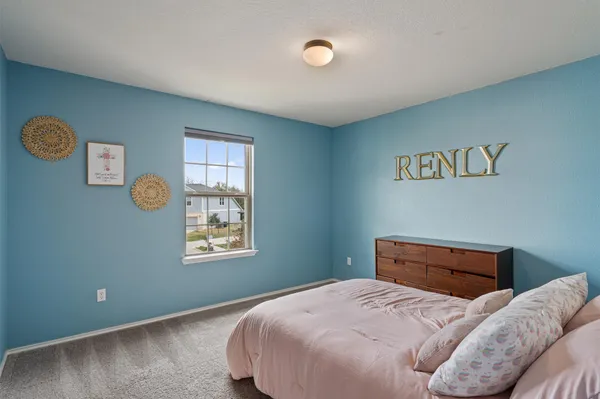 a bedroom with bed and window