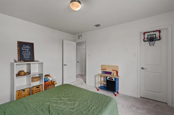 a bedroom with a bed and a view of bedroom