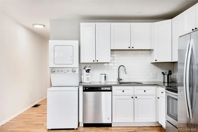 a kitchen with white cabinets and white appliances