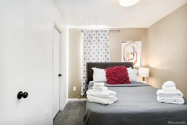 a bedroom with a bed and window