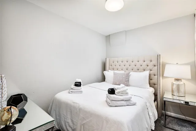 a bedroom with a bed and a lamp