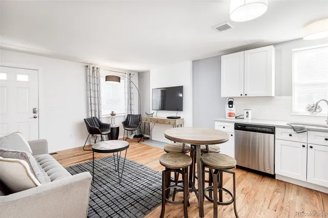 a view of kitchen with cabinets table and chairs