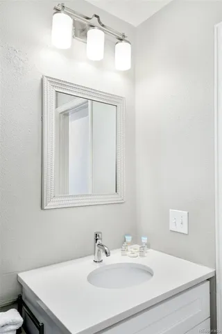 a bathroom with a sink vanity and a mirror