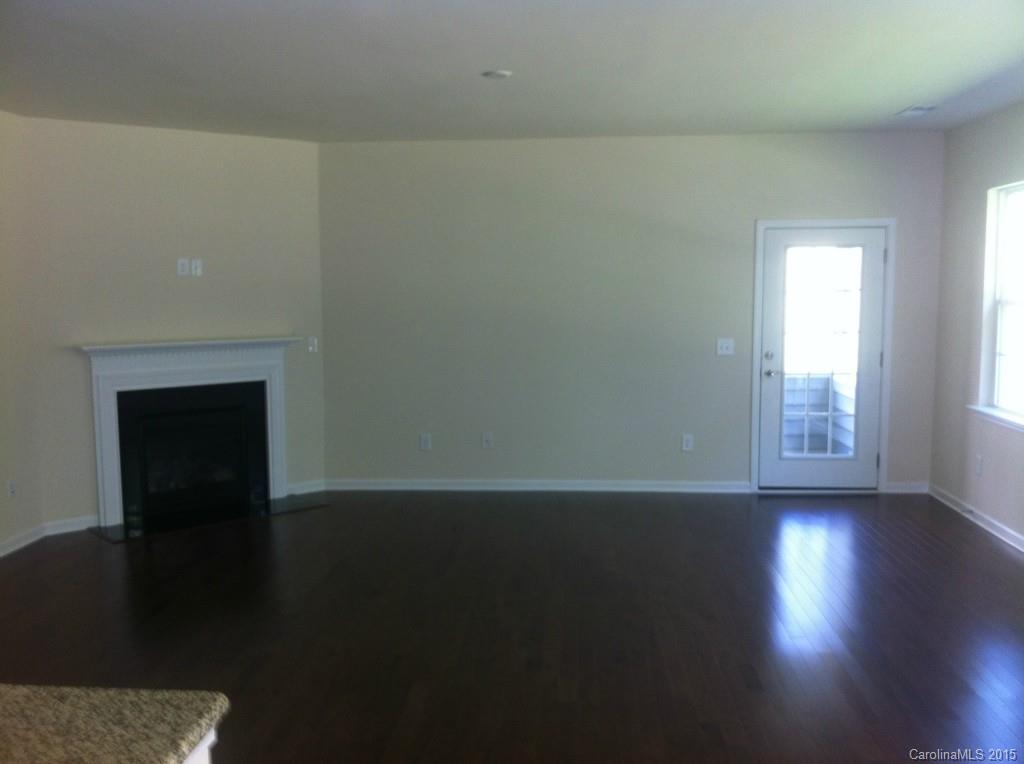 4225 Perth Road, Unit 344 Indian Land, SC 29707 - Photo 7 of 14 a view of an empty room with wooden floor and a window