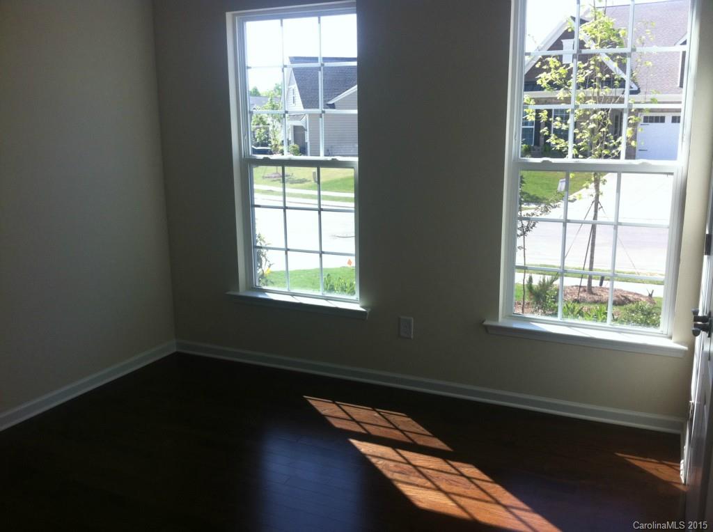 4225 Perth Road, Unit 344 Indian Land, SC 29707 - Photo 8 of 14 a view of an empty room with wooden floor and a window