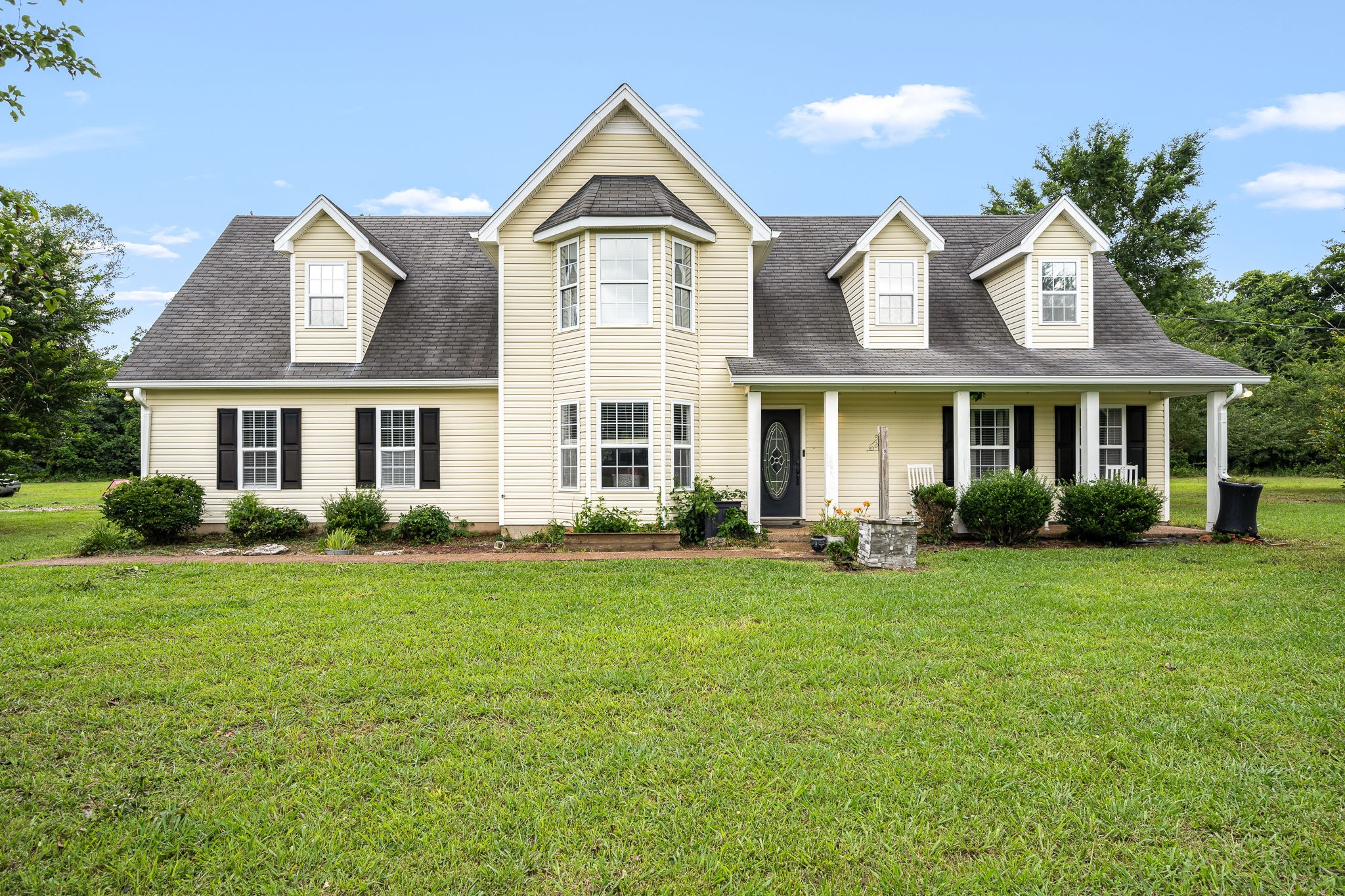 a front view of a house with a garden
