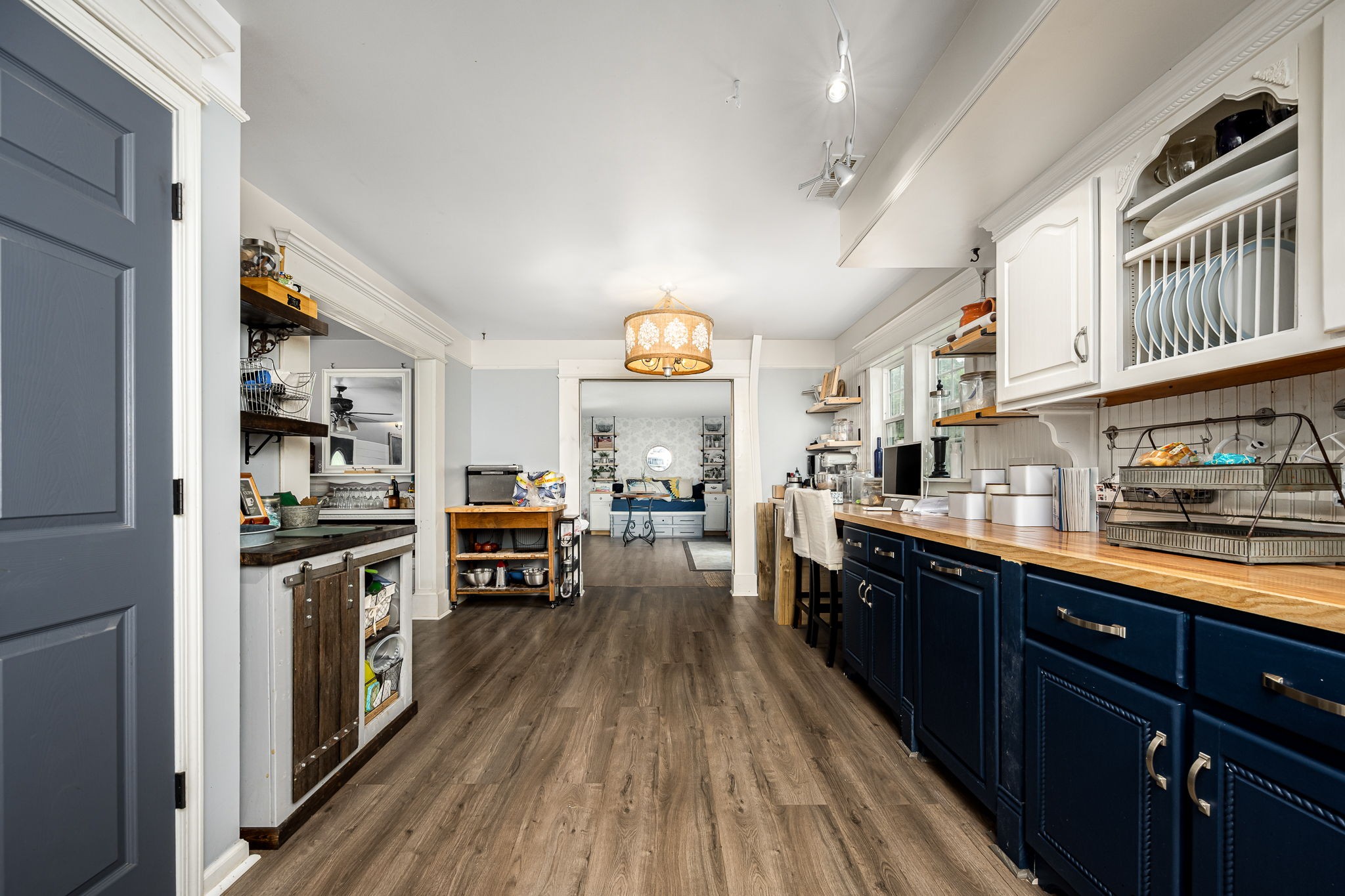 4842 Lunns Store Road Chapel Hill, TN 37034 - Photo 28 of 52 a kitchen with stainless steel appliances a stove top oven a sink dishwasher and a dining table with wooden floor