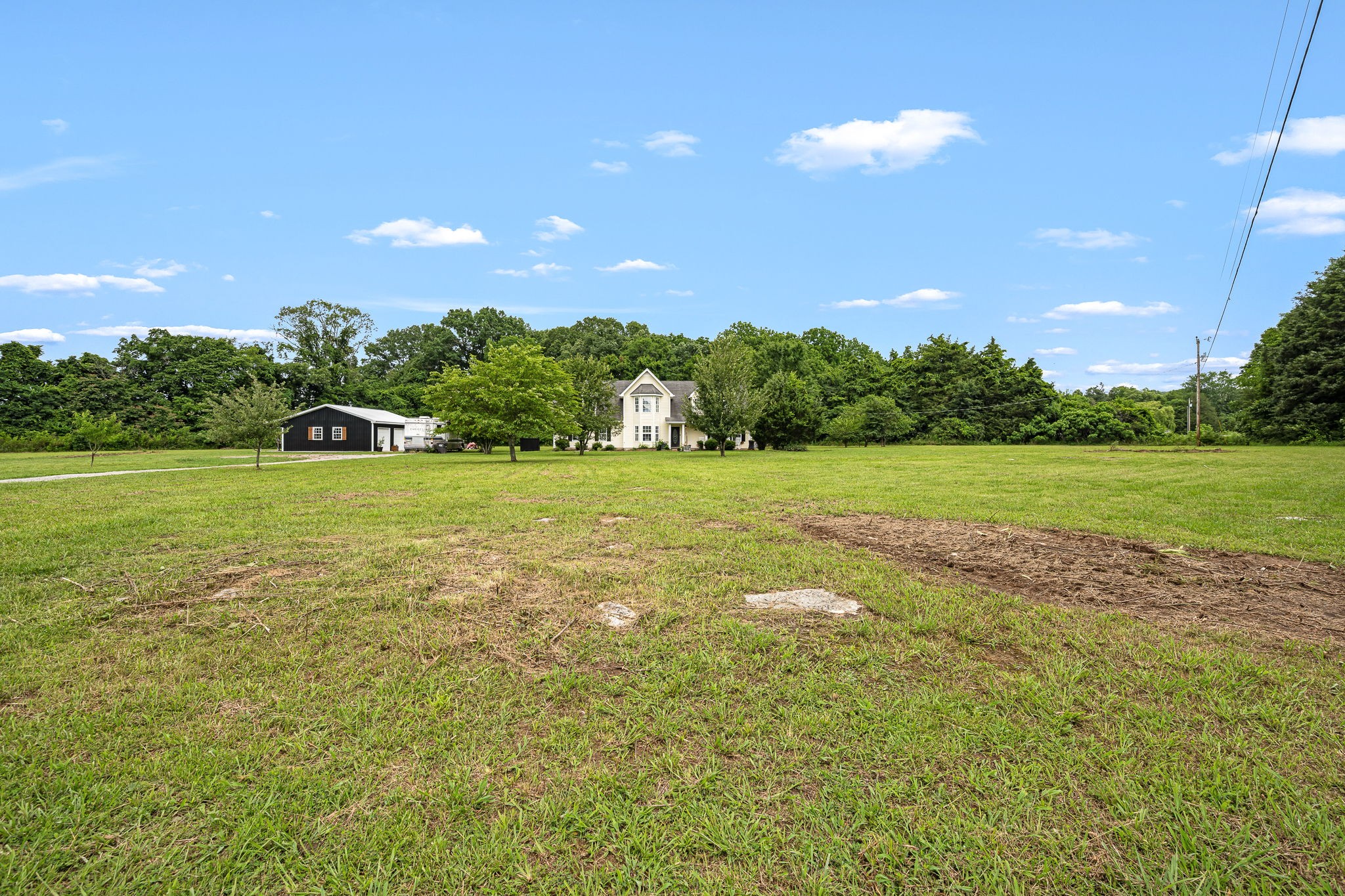4842 Lunns Store Road Chapel Hill, TN 37034 - Photo 8 of 52 a view of a green yard with a house in the background