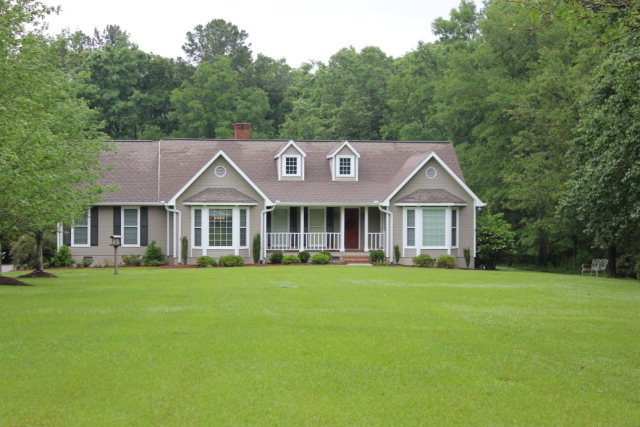 a front view of a house with a garden