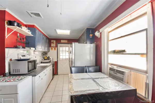 a kitchen with a stove a refrigerator and a sink