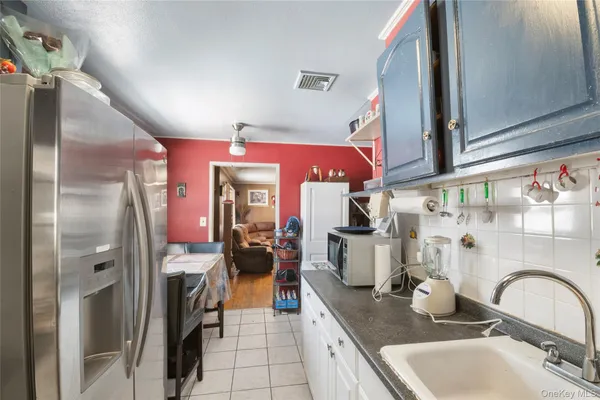 a kitchen with refrigerator and cabinets