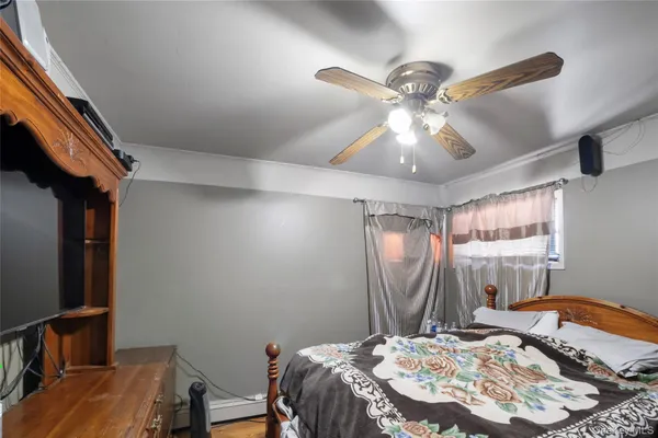 a bed sitting in a bedroom next to a window