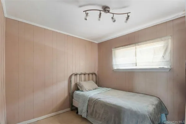 a bedroom with a bed and window