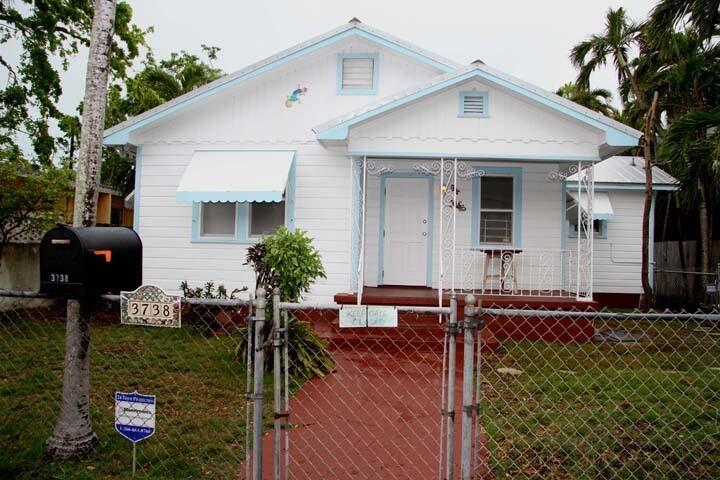 a front view of house with yard outdoor seating and barbeque oven