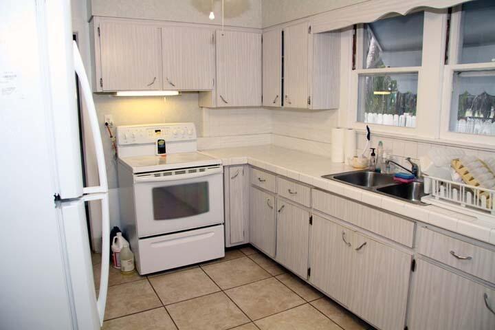 3738 Eagle Avenue Key West, FL 33040 - Photo 11 of 37 a kitchen with white cabinets and white appliances