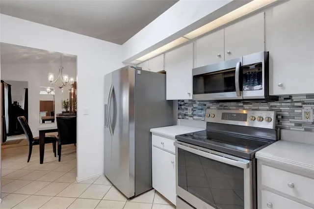 a kitchen with cabinets a sink and appliances