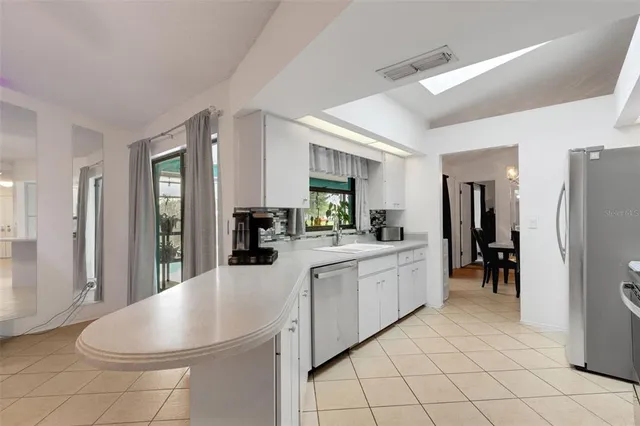 a kitchen with a sink cabinets and window