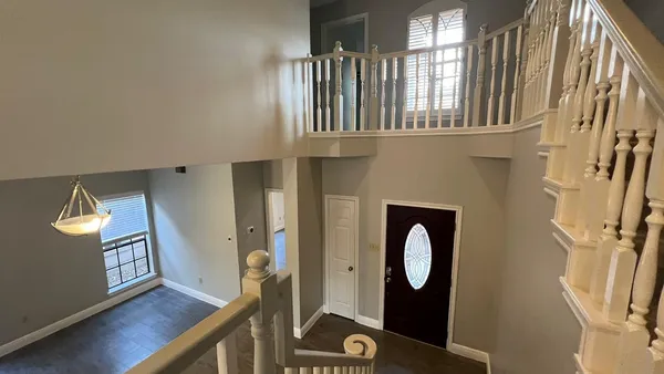 a view of an entryway with wooden floor