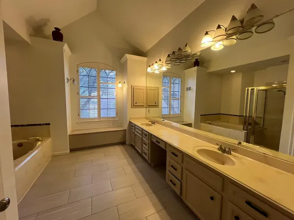 a large bathroom with a large tub and sink