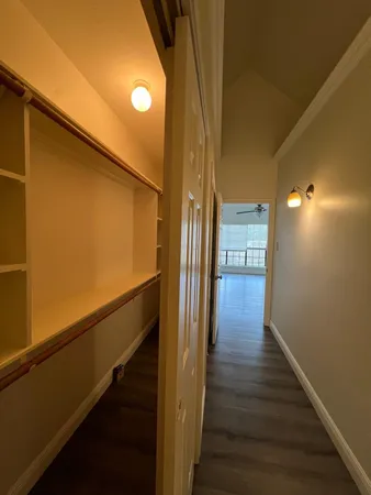 a view of a hallway with wooden floor