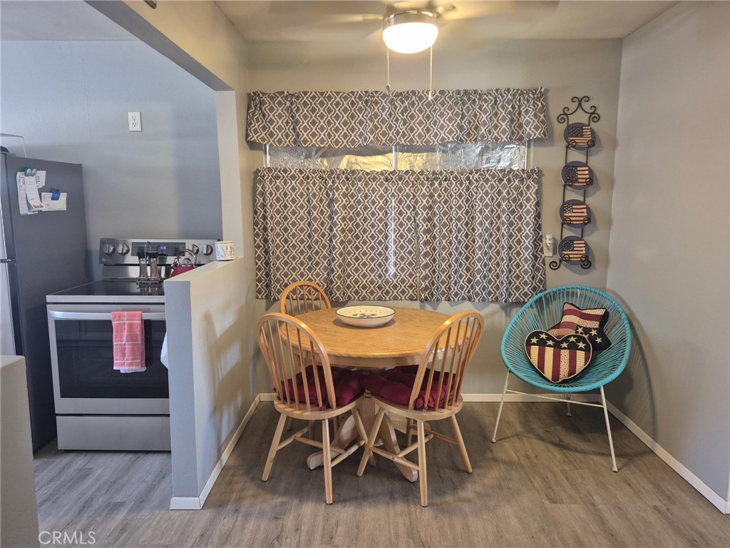 63737 Gibson Road Joshua Tree, CA 92252 - Photo 14 of 25 a view of a dining room with furniture and wooden floor