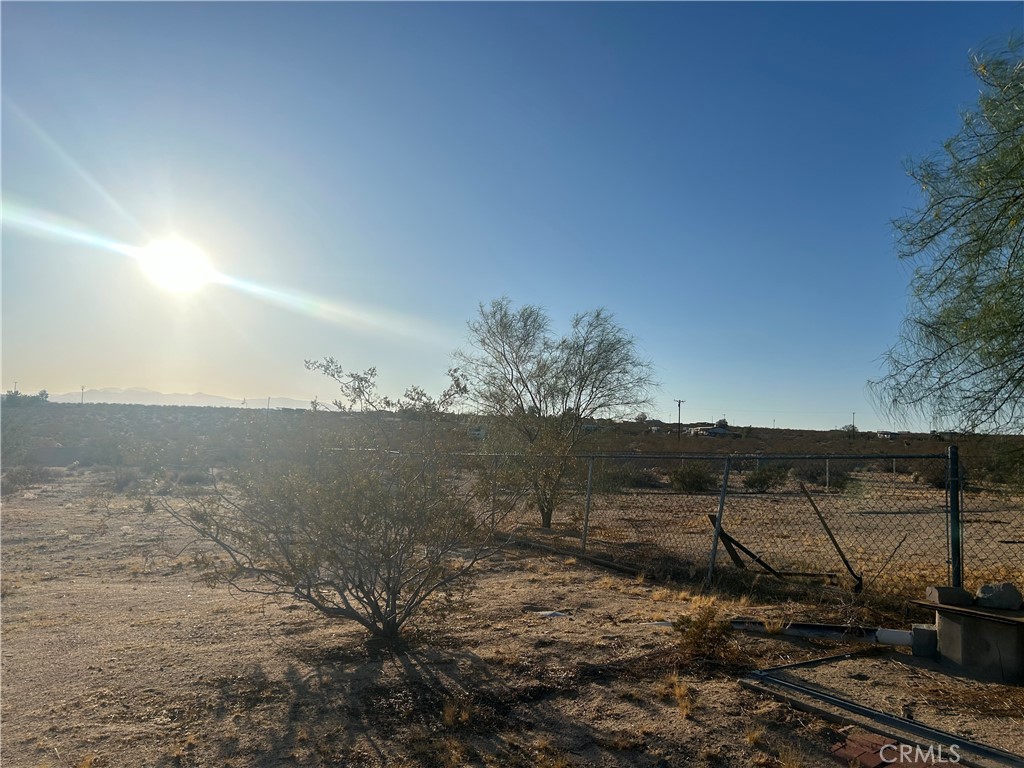 63737 Gibson Road Joshua Tree, CA 92252 - Photo 22 of 25 a view of a dry yard with wooden fence