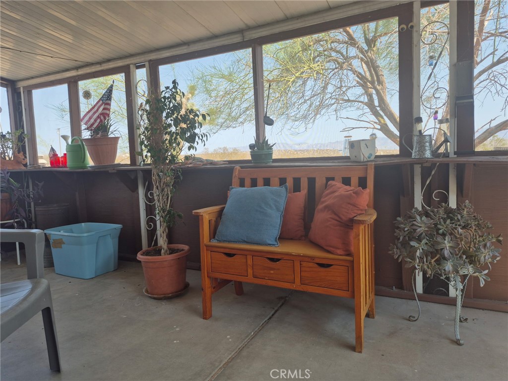 63737 Gibson Road Joshua Tree, CA 92252 - Photo 7 of 25 a living room with furniture and a potted plant