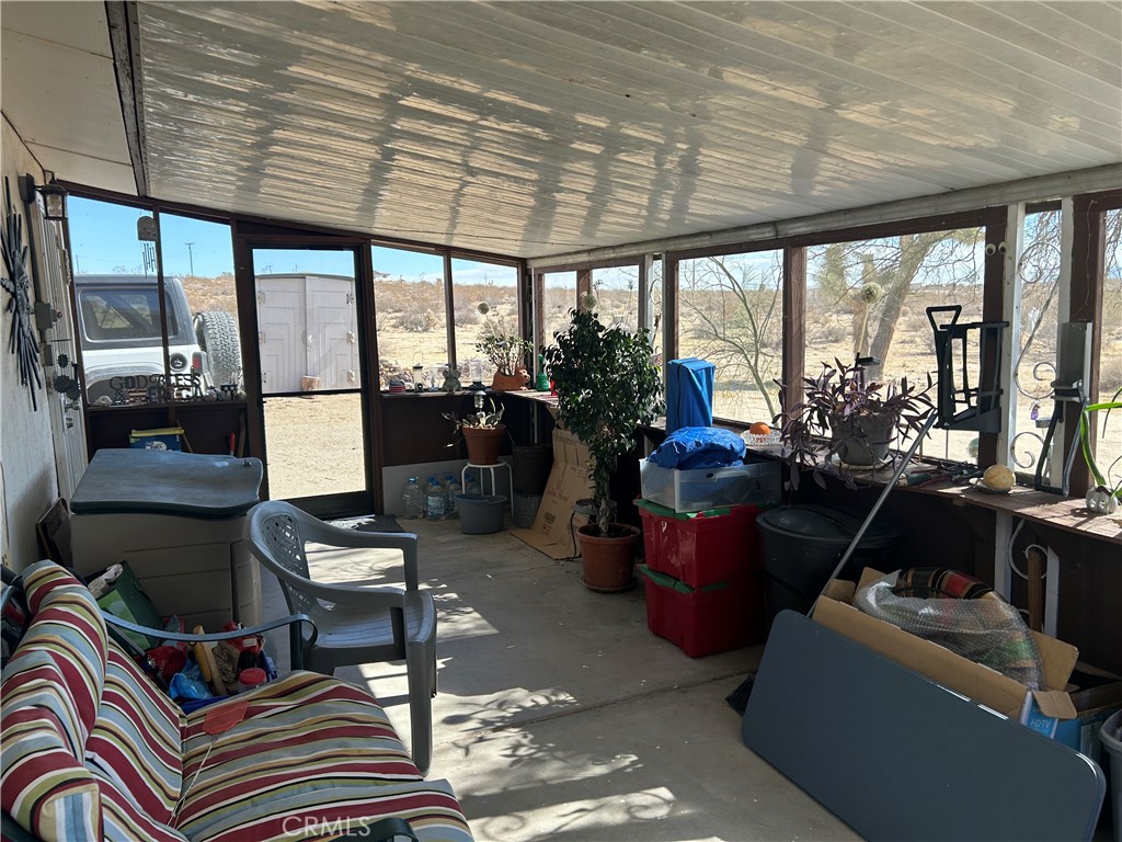 63737 Gibson Road Joshua Tree, CA 92252 - Photo 10 of 25 a living room with furniture and a floor to ceiling window