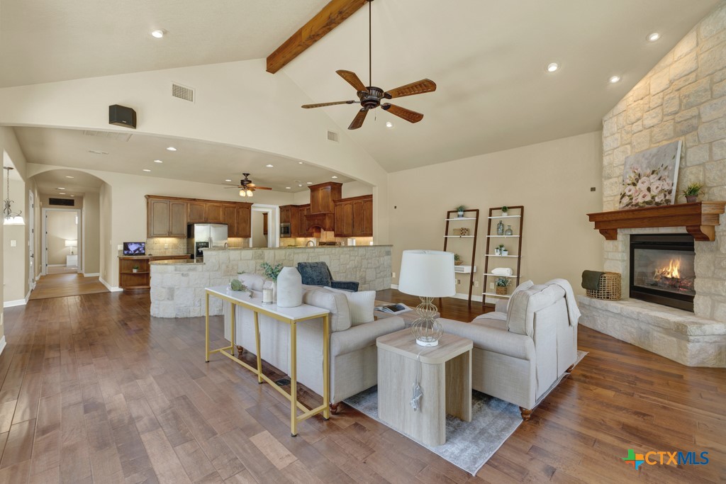 7607 Sky Loop Garden Ridge, TX 78266 - Photo 16 of 43 a living room with fireplace furniture and a wooden floor