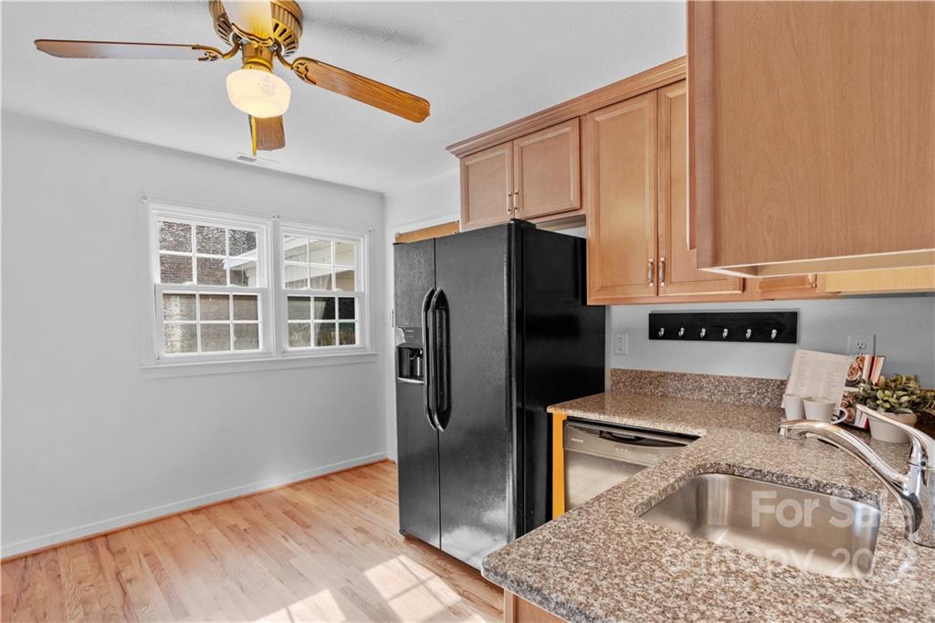 3408 Anson Street, Unit E3 Charlotte, NC 28209 - Photo 11 of 26 a kitchen with stainless steel appliances granite countertop a refrigerator a stove and a sink