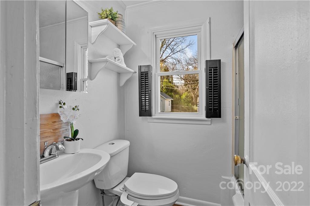 3408 Anson Street, Unit E3 Charlotte, NC 28209 - Photo 15 of 26 a bathroom with a sink a toilet and a mirror