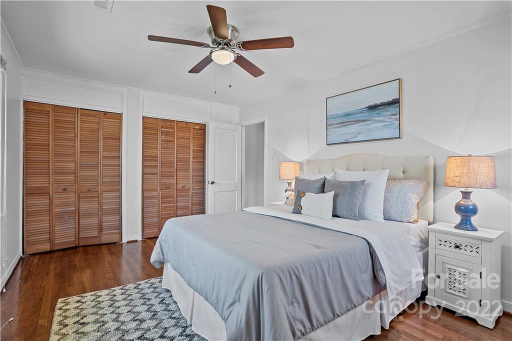 3408 Anson Street, Unit E3 Charlotte, NC 28209 - Photo 17 of 26 a bedroom with a bed and wooden floor