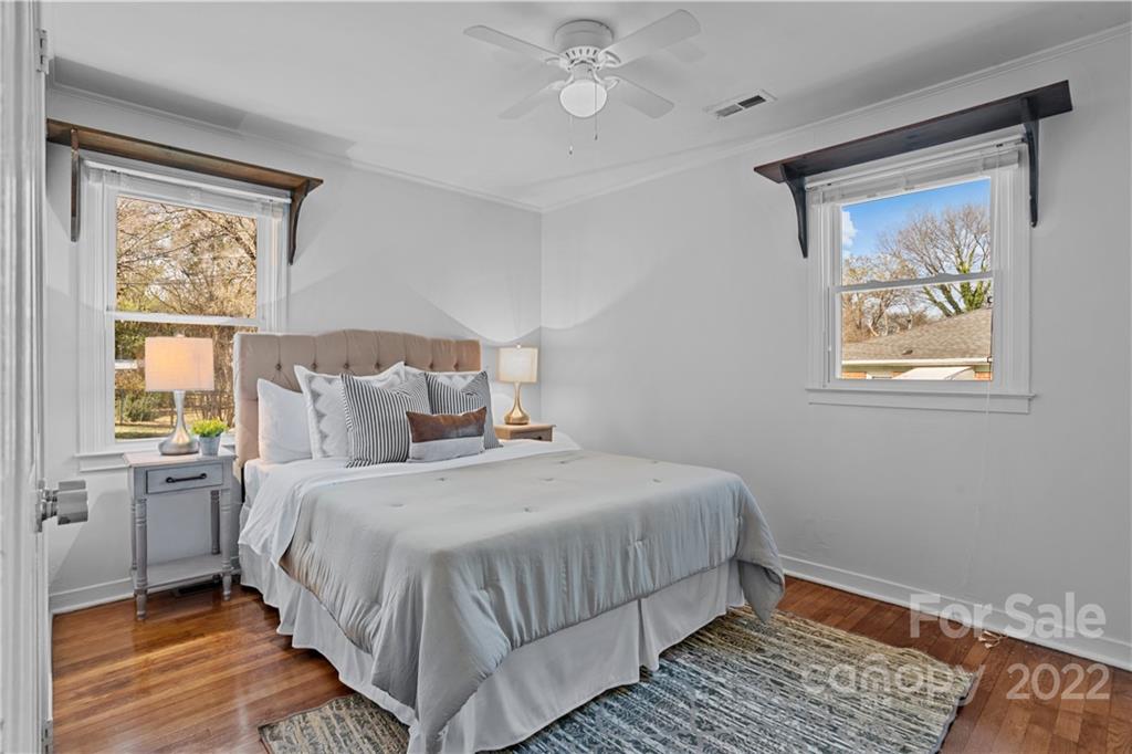 3408 Anson Street, Unit E3 Charlotte, NC 28209 - Photo 19 of 26 a bedroom with a bed lamp and a window