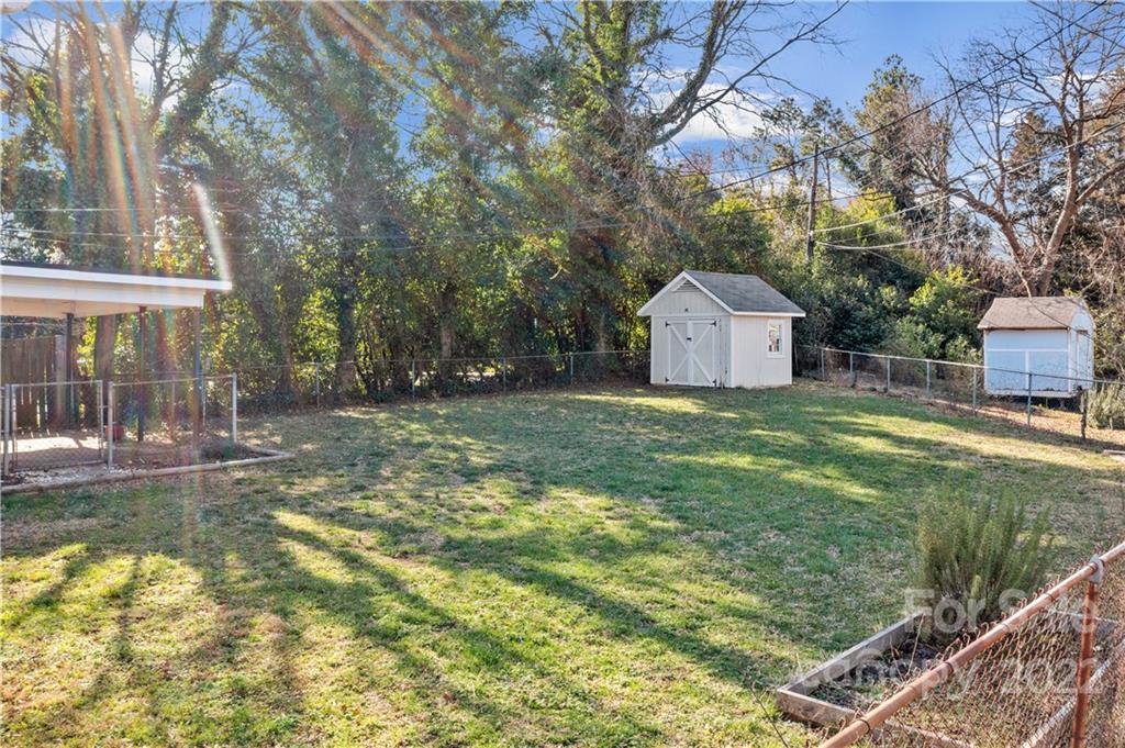 3408 Anson Street, Unit E3 Charlotte, NC 28209 - Photo 23 of 26 a view of a house with a yard and large tree