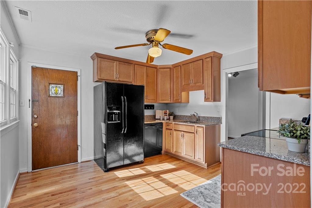 3408 Anson Street, Unit E3 Charlotte, NC 28209 - Photo 8 of 26 a kitchen with granite countertop a refrigerator and a stove top oven