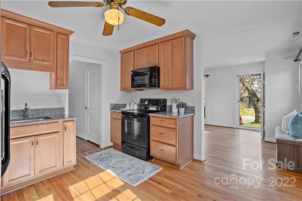 3408 Anson Street, Unit E3 Charlotte, NC 28209 - Photo 9 of 26 a kitchen with granite countertop a stove a sink and a cabinets