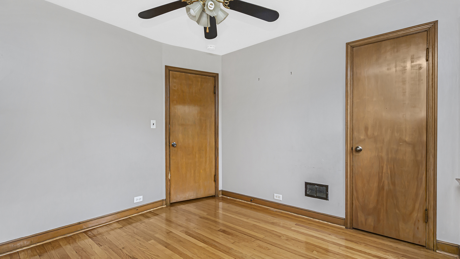 2322 South 7th Avenue North Riverside, IL 60546 - Photo 11 of 21 an empty room with wooden floor and a ceiling fan