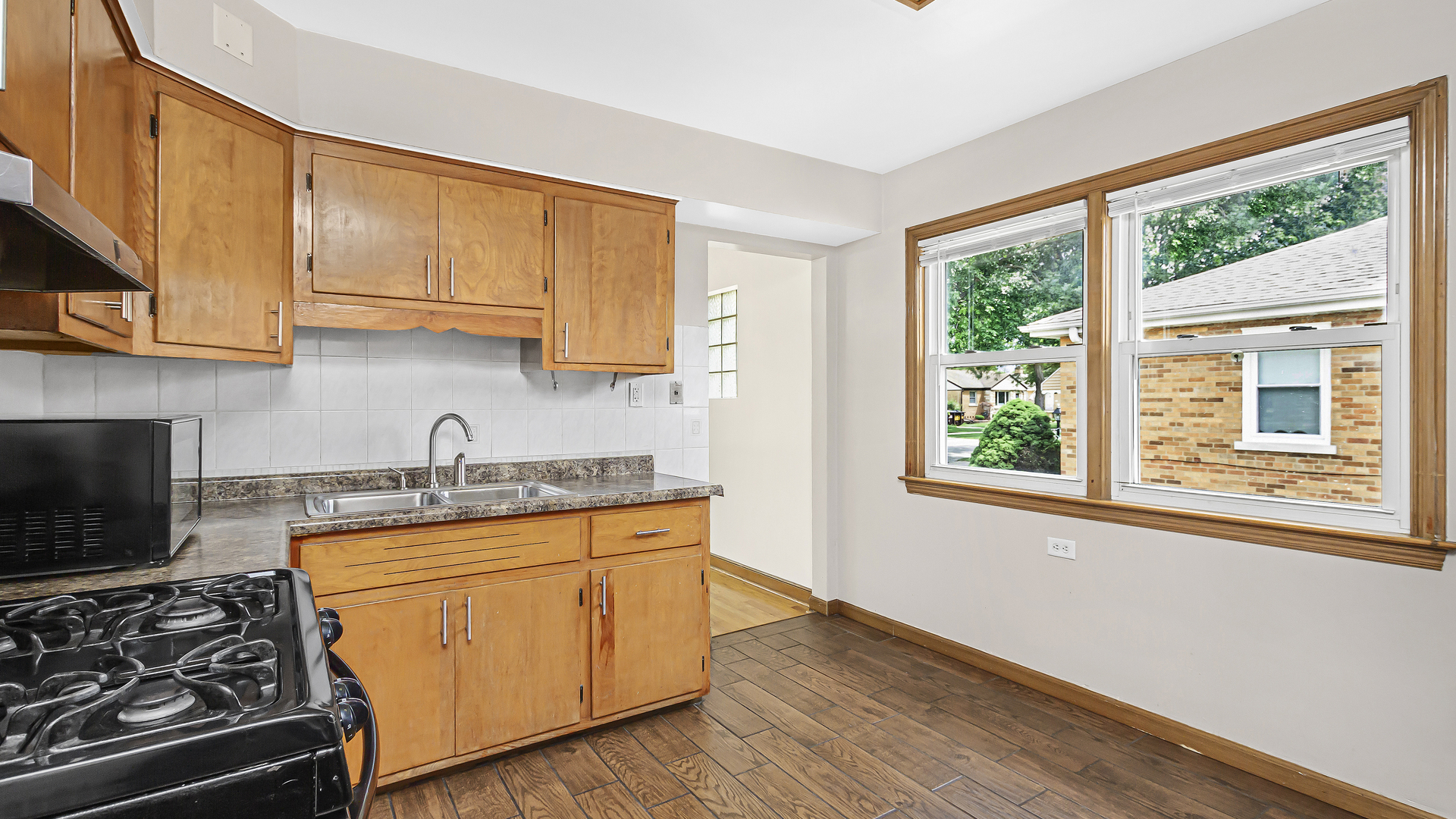 2322 South 7th Avenue North Riverside, IL 60546 - Photo 10 of 21 a kitchen with stainless steel appliances granite countertop wooden cabinets stove top oven and sink