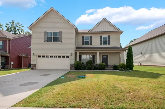 a front view of a house with a yard