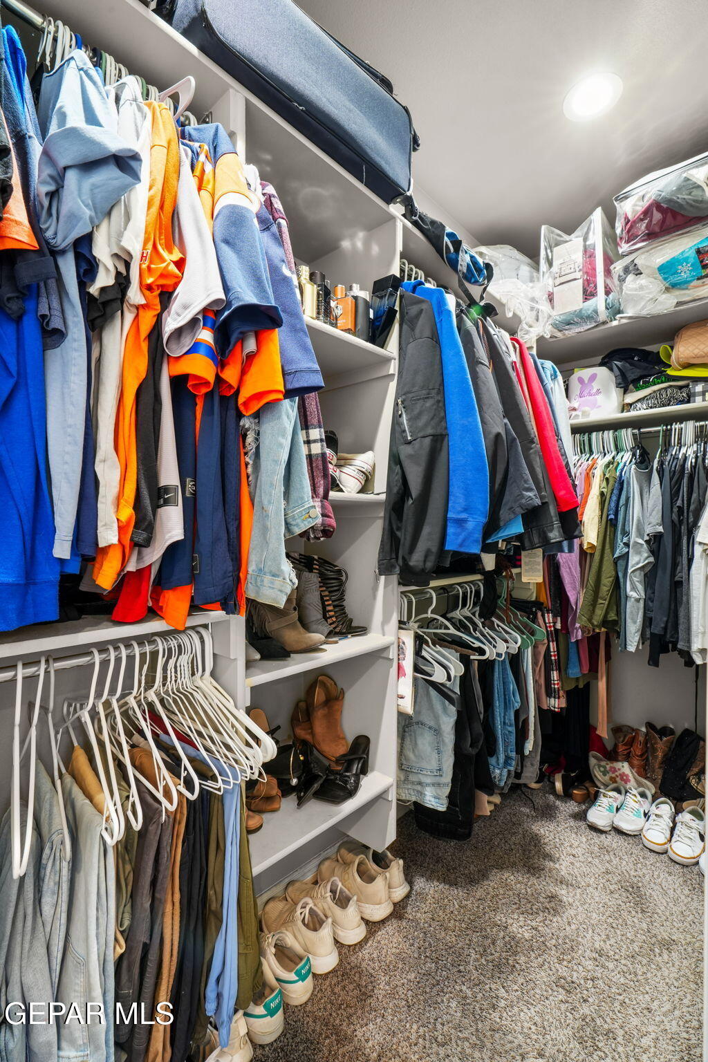 13737 Garforth Avenue El Paso, TX 79928 - Photo 23 of 34 a view of walk in closet with clothes and shoes