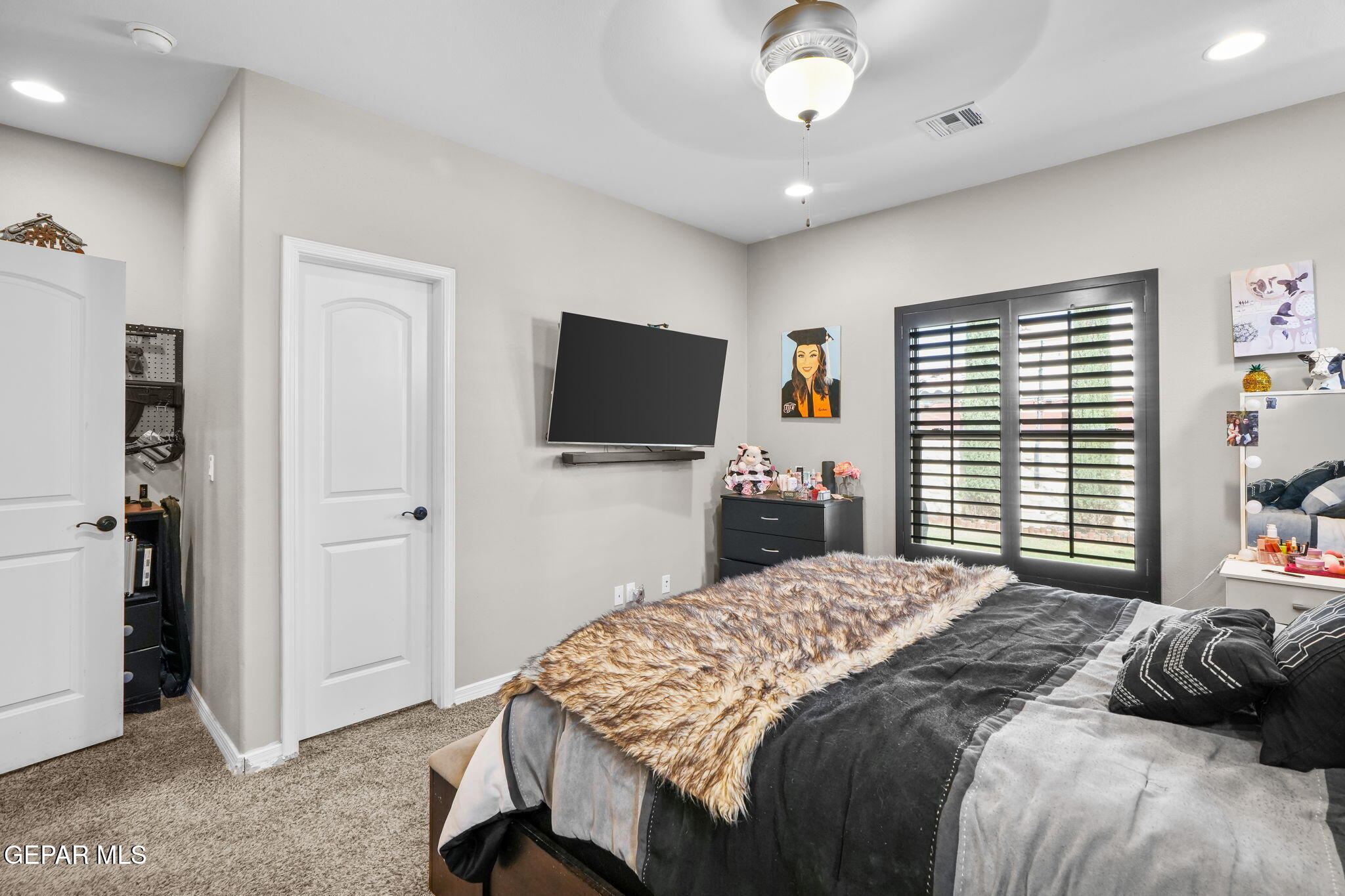 13737 Garforth Avenue El Paso, TX 79928 - Photo 26 of 34 a bedroom with a bed and a flat screen tv