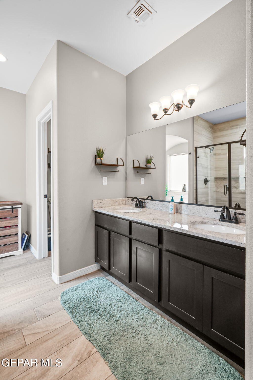 13737 Garforth Avenue El Paso, TX 79928 - Photo 28 of 34 a bathroom with a granite countertop sink and a mirror