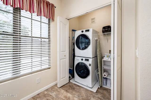 a spacious bedroom with a bed and a chandelier