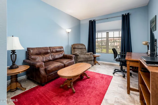 a living room filled with furniture and a window
