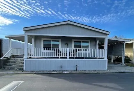 a view of a house with wooden fence