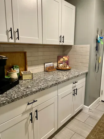 a kitchen with stainless steel appliances granite countertop a sink and cabinets