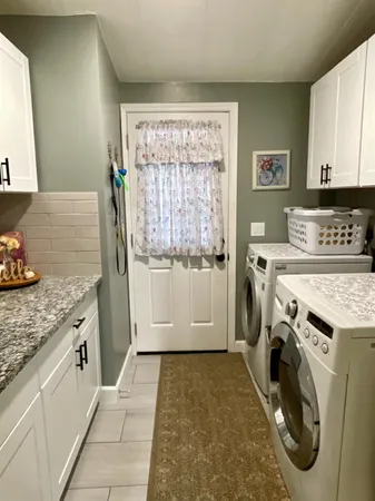 a view of a kitchen with utility area and washer dryer