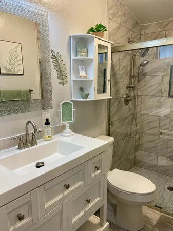 a bathroom with a sink mirror vanity and toilet