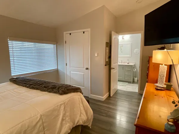 a bedroom with a bed and flat screen tv