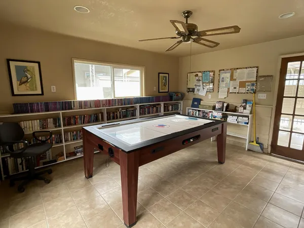 a room with furniture pool table and windows